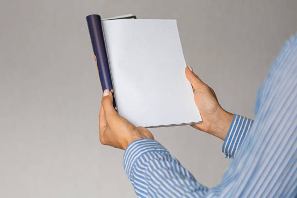istock female hands holding mock up magazine indoorsnews knowledge study 1415302047