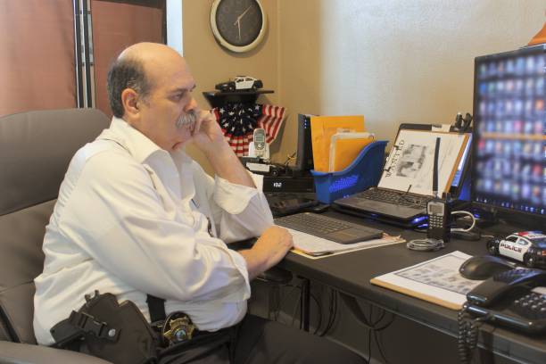 istock older male detective at his desk 1415304506