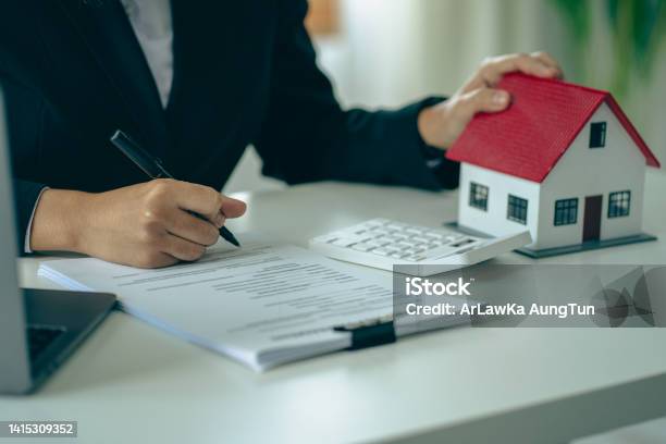 Model Homes With Real Estate Agents And Home Purchase Contracts Insurance Or Real Estate Loans In The Sales Office Stock Photo - Download Image Now