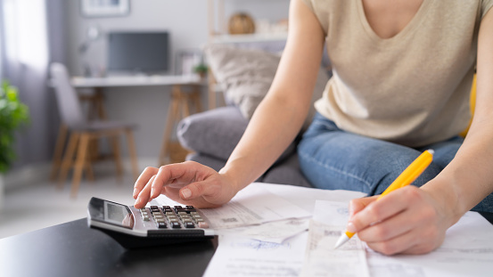 Woman doing taxes at her home trough economic crisis