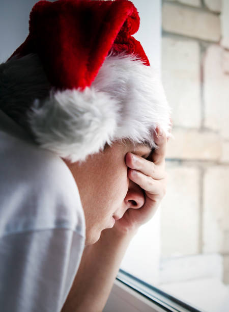 istock Sad Man in Santa Hat 1415312120