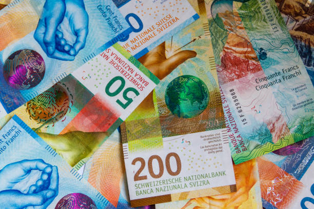 istock Background of the different swiss francs banknotes 1415312375