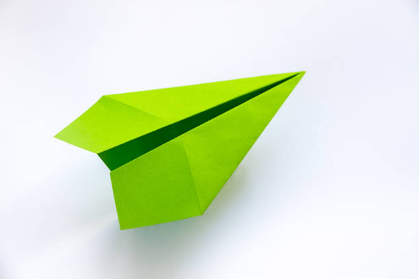istock Green paper plane origami isolated on a white background 1415312528