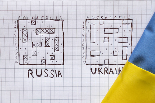 drawing of a children's game sea battle with the text Russia and Ukraine in a notebook, the field of Russian ships is broken, Russia's failure in the war with Ukraine, no war