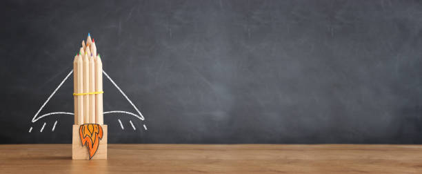 istock education. Back to school concept over wooden table and blackboard background 1415316988