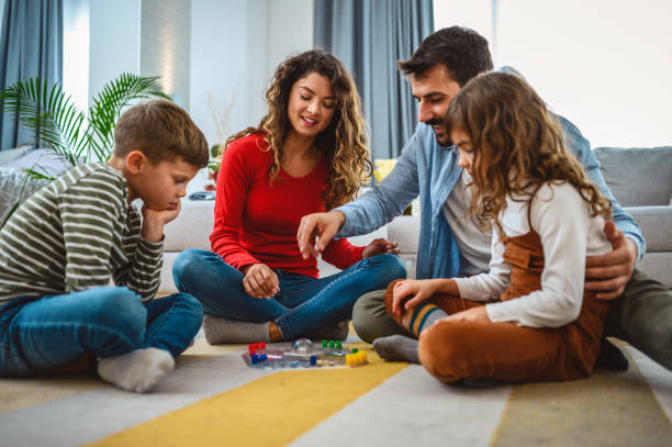istock Cheerful parents playing board game with their children. 1415319186