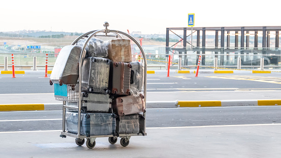 Porter cart with suitcase at the airport, front view