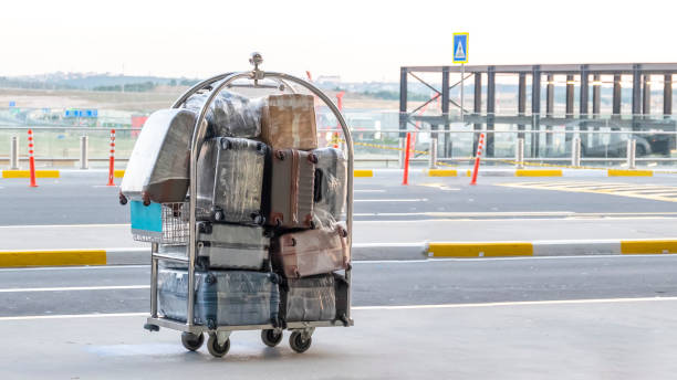 Porter cart with suitcase at the airport Porter cart with suitcase at the airport, front view airport porter stock pictures, royalty-free photos & images