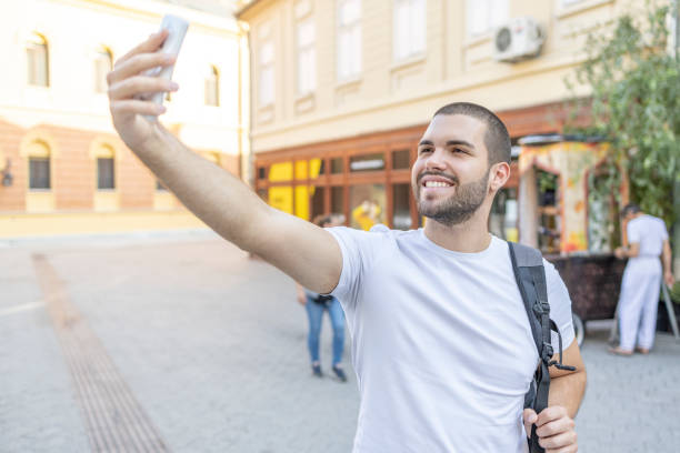 istock Male student taking a selfie outdoors 1415321330
