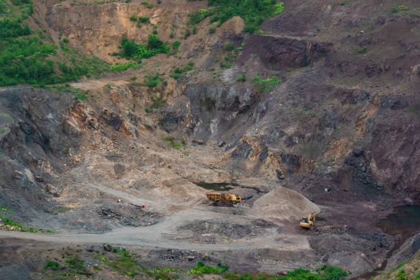 istock small quarry with mining machinery in mountainous area 1415322387