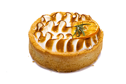 Tartlet with Italian meringue and lemon cream on a wooden stand, selective focus.