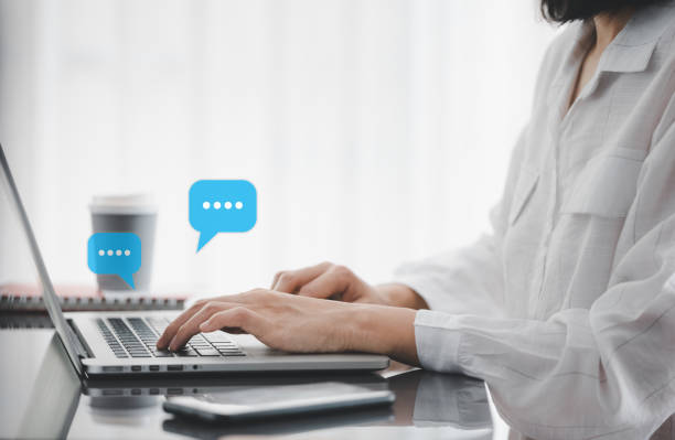istock closeup woman hands typing on laptop with message icon as chatting 1415325247