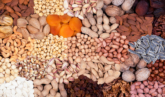 Assortment of nuts and fruits collected in one  frame.