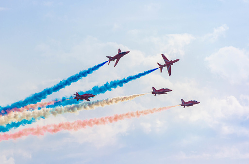 Red arrow display team in formation with smoke trails. Blue sky at Blackpool air show