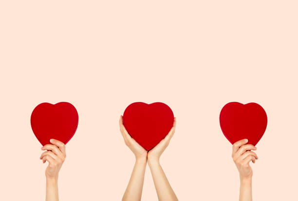 istock Hands holding heart shaped box with isolated background. 1415326537