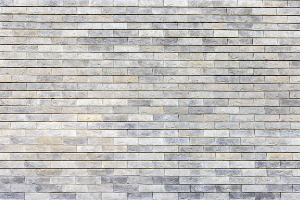 istock Natural stone color brick wall textured background 1415326892
