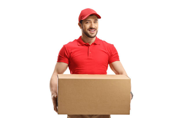 istock Young delivery man with a cardboard package 1415329881