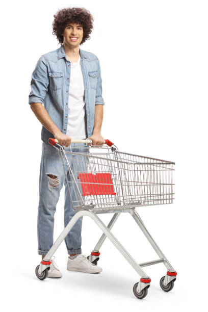 istock Guy with curly hair standing with an empty shopping cart 1415331022