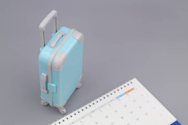 istock Calendar and suitcase on gray background. 1415332267
