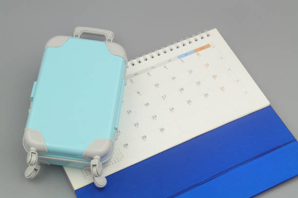 istock Calendar and suitcase on gray background. 1415332340