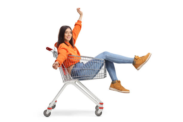 istock Young happy female sitting inside a shooping cart 1415332592