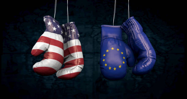 Hanging boxing gloves with the flag of the United States of America and the flag of the European Union illustrate the tensions between the two countries - 3d illustration stock photo