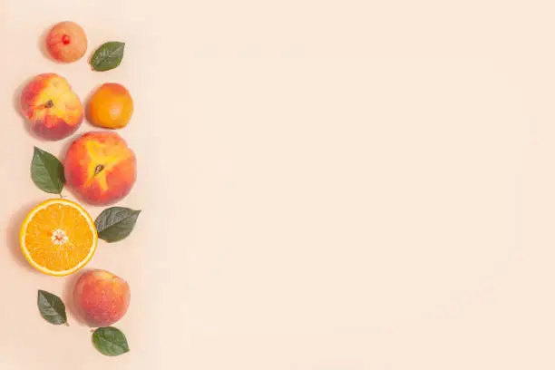 Delicate pink background with fruits - elegant minimalist composition