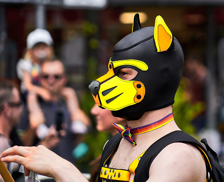 Braunschweig, Germany, August 13, 2022: Portrait of a man with a black and yellow face mask of a fox at CSD parade