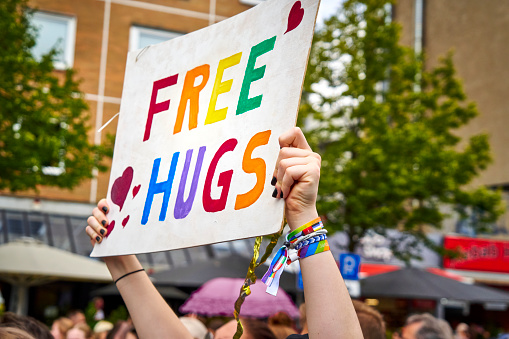 Braunschweig, Germany, August 13, 2022: Poster with wish or promise for free hugs at CSD parade