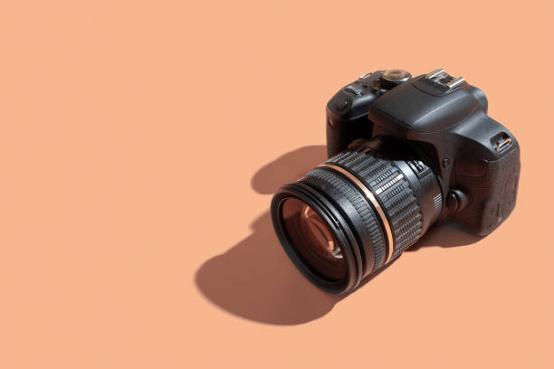 istock SLR camera with a lens on a colored background 1415333886