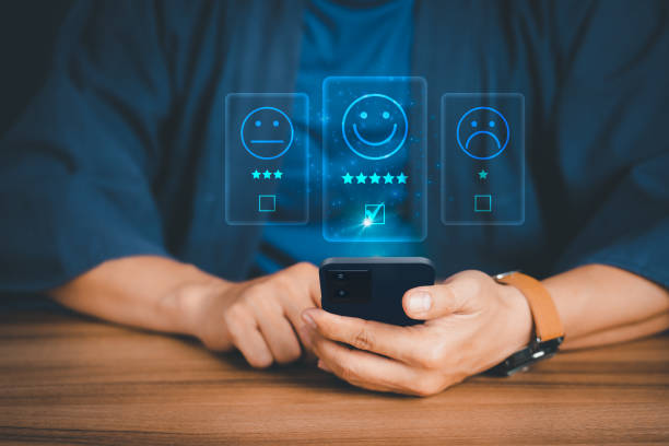 istock Man using a mobile phone in give rating to service experience on application. Online customer review satisfaction feedback survey. 1415336951