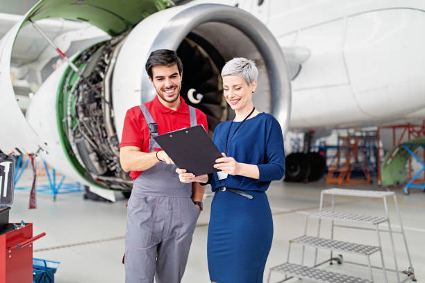 istock Manager and mechanic in airplane hangar 1415339193