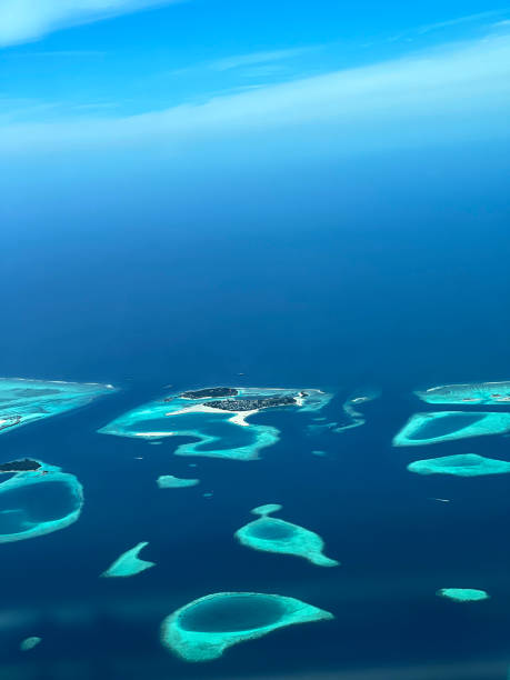 maldives from point of airplane view vertical aerial photo sea and sky are blue stock photo