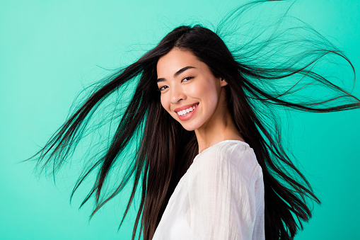 Profile photo of cheerful stunning girl toothy smile flying long black hair isolated on vibrant cyan color background.