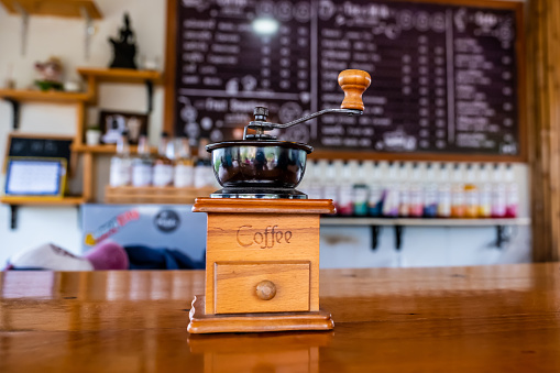 Manual coffee grinder in cafe. vintage coffee grinder on coffee shop.