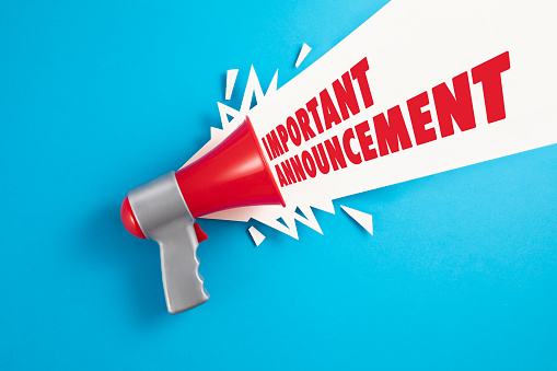 Red megaphone with colored papers and important announcement text on blue background