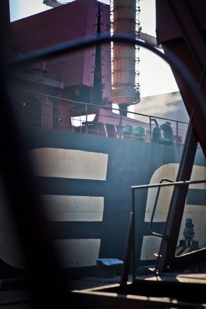 istock Loading grain into holds of sea cargo vessel in seaport from grain storage. 1415341709