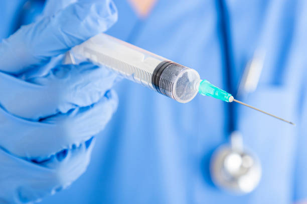 istock Unrecognizable nurse holding a syringe and pointing it at camera 1415341850