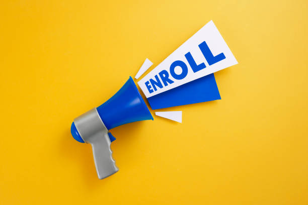 Enroll Blue megaphone with enroll message on yellow background enrollment stock pictures, royalty-free photos & images