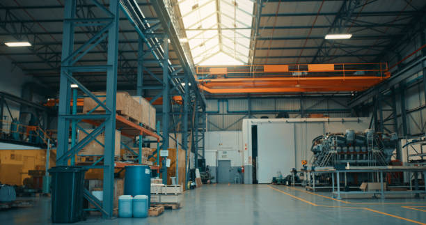 Big empty warehouse factory with boxes, manufacturing and industrial workshop goods in storage ready for delivery. Large industry cargo storehouse building interior with stock, freight or packages