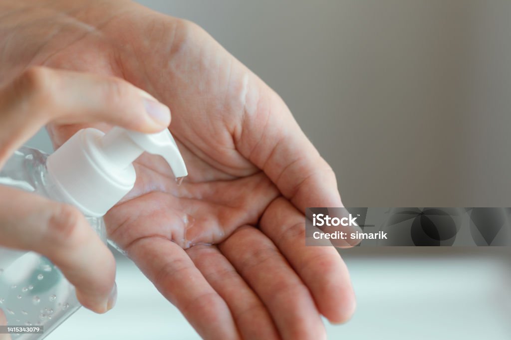 Hygiene Hand is about to use hand sanitizer. Hand Sanitizer Stock Photo