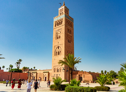 Marrakesh, Morocco - 22 September 2019 : view of Kotoubia mosque with tourists and local water sellers