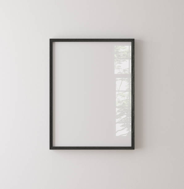 istock Black painted wooden frame mockup close up on white wall 1415352818