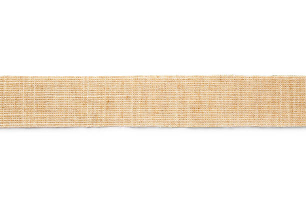 Wide burlap ribbon on white background, top view Wide burlap ribbon on white background, top view hessian texture stock pictures, royalty-free photos & images