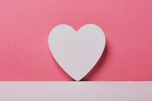 White heart on pink background
