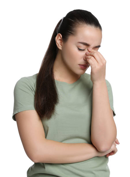 istock Young woman suffering from headache on white background 1415354809