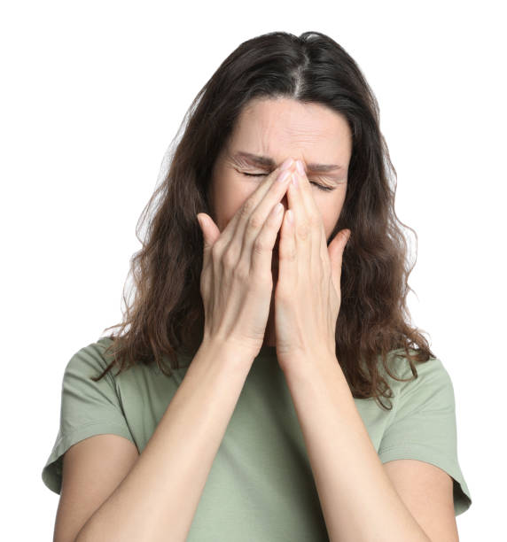 istock Mature woman suffering from headache on white background 1415354872