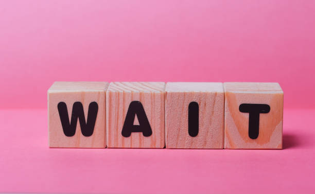 istock WAIT  word on wooden cubes 1415354879