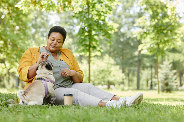 Woman with Cute Pug on Grass