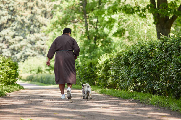 istock Woman with Dog walking Together 1415356450